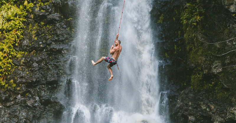 man hanging on rope