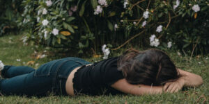 Woman laying on the ground tired