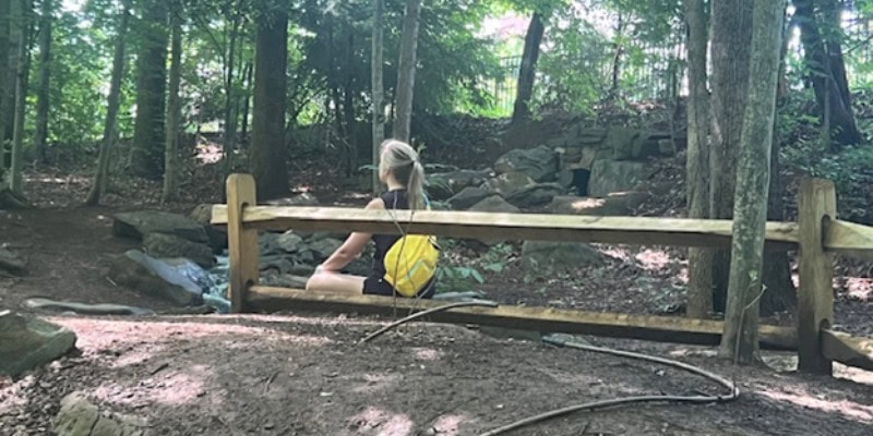Hiker sitting in woods resting